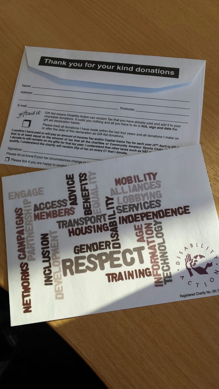 photo of the front and back of Disability Action Gift Aid donation envelopes