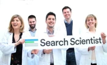 four people in lab coats holding a seatch scientist banner